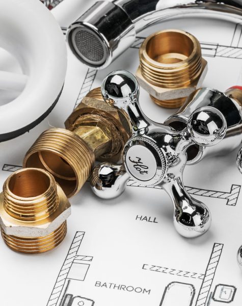 plumbing and tools lying on drawing for repair